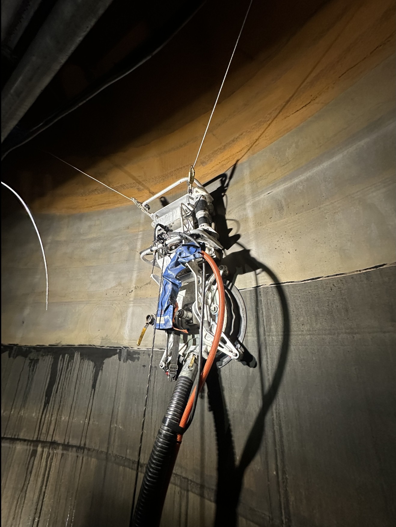Robotic surface preparation equipment cleaning the interior wall of an industrial tank